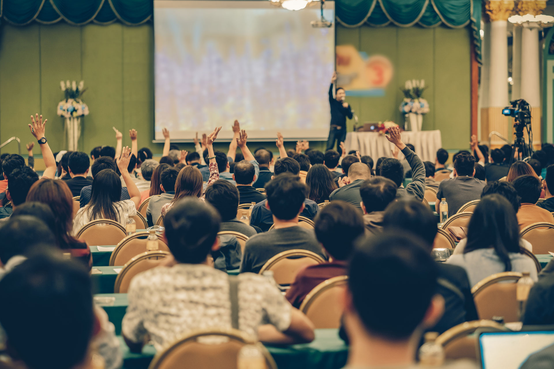 Rear view of Audience showing hand to answer the question from S Helping business achievement.